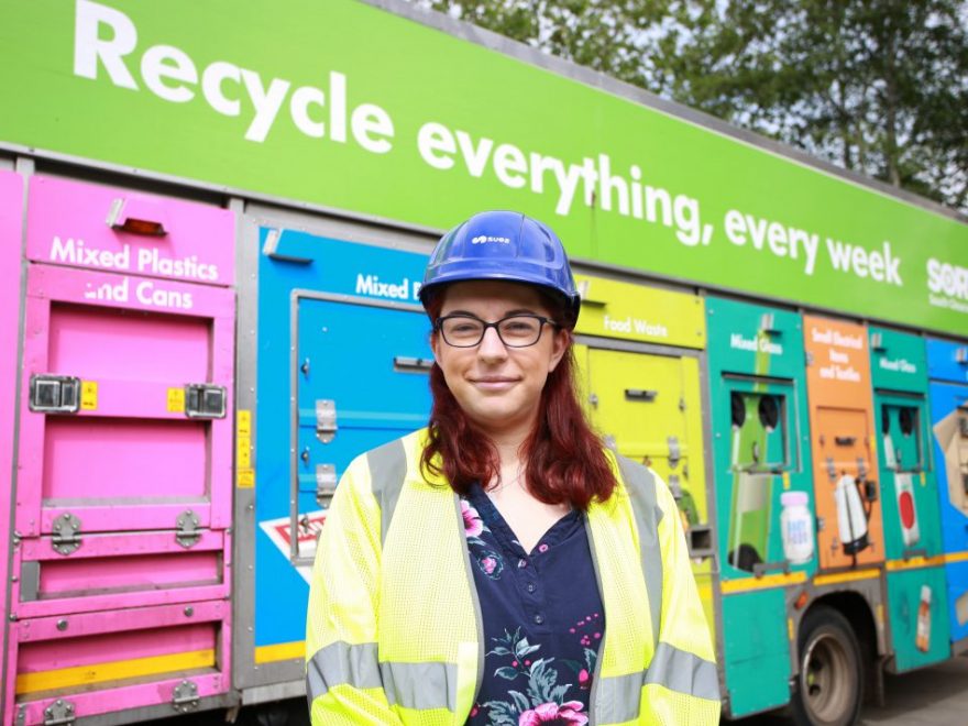 Photo of Cllr Rachael Hunt standing in front of a recycling collection vehicle.