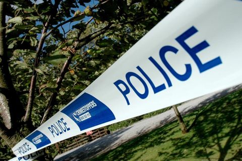 Photo of blue and white plastic tape carrying the word 'Police'.