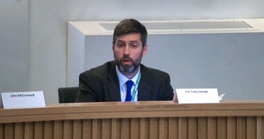 Cllr Toby Savage speaking at a meeting of South Gloucestershire Council's Cabinet on 5th December 2022. Photo of a man chairing a council meeting.
