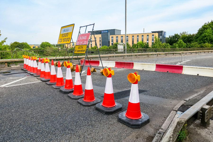 Photo of road closure signs on a bridge.